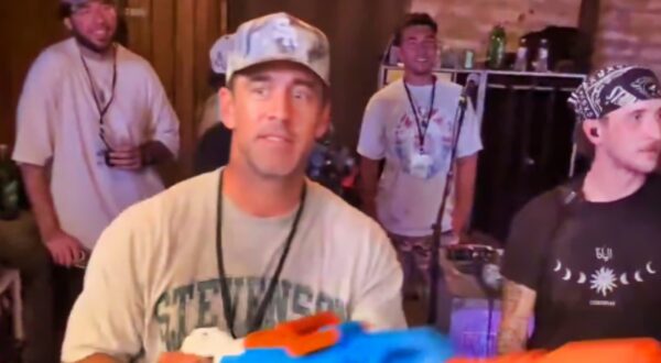 Aaron Rodgers with water gun in hand