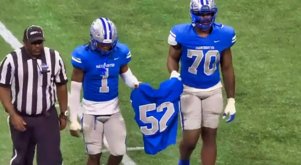 Brandon Smith's jersey being held by teammates