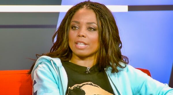 Jemele Hill sitting on couch