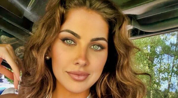 Katherine Webb psing in golf cart