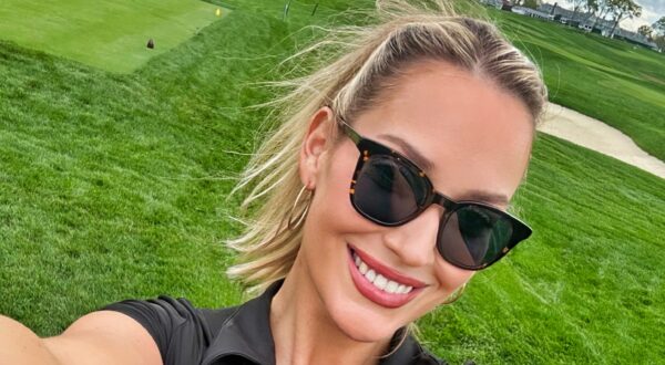 Paige Spiranac posing on golf course