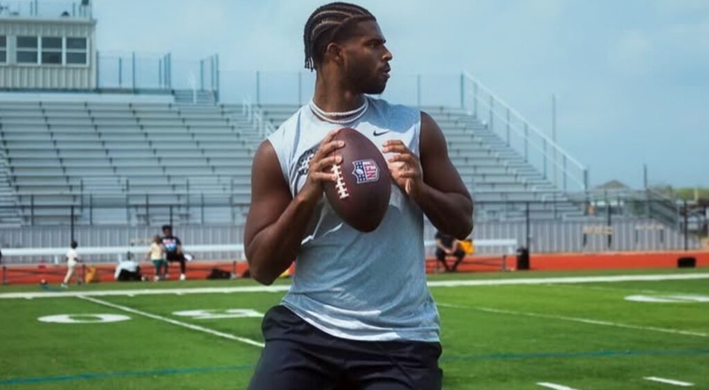 Shedeur Sanders holding football