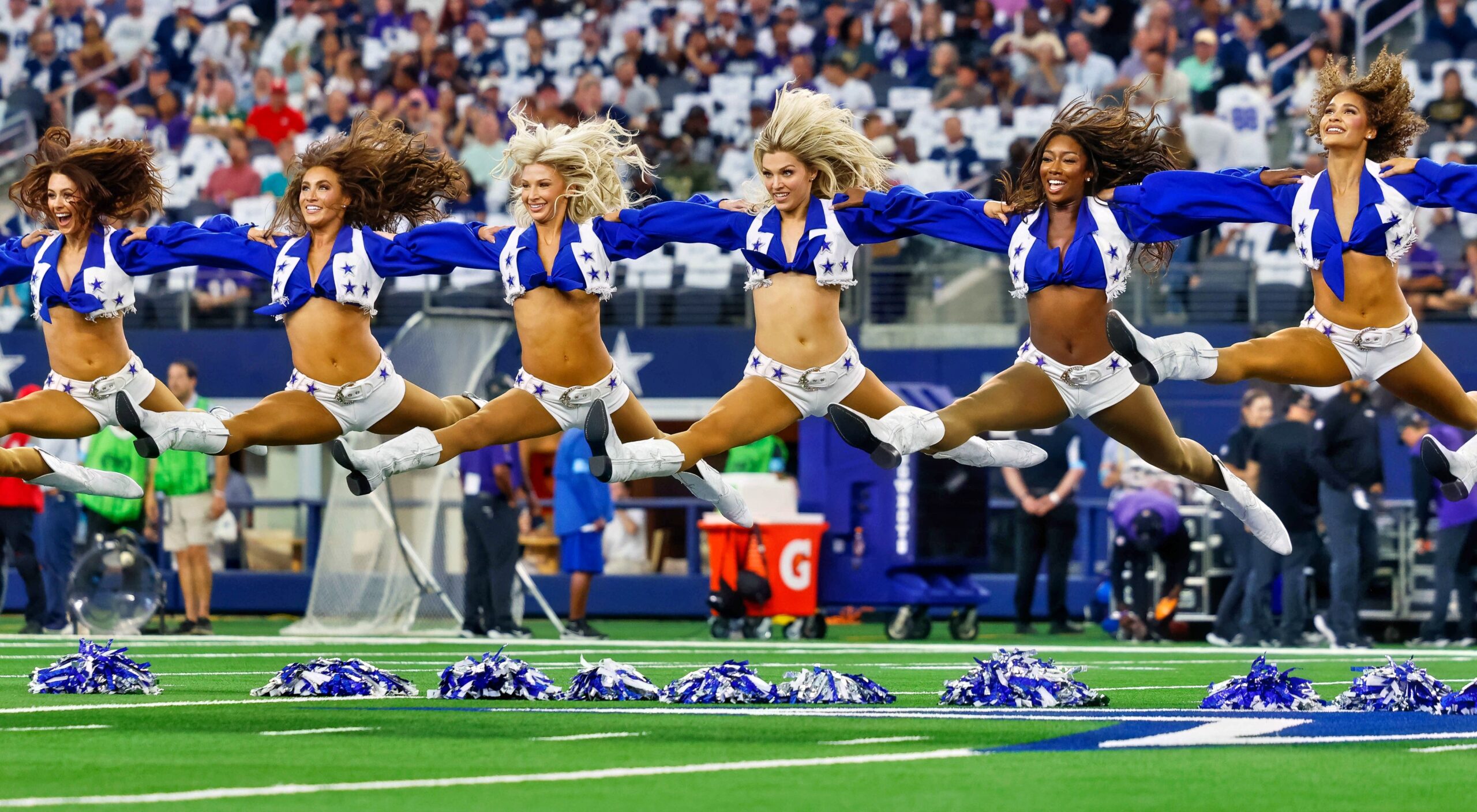 The Dallas Cowboys Cheerleaders jumping in the air