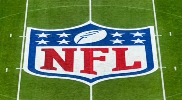 NFL logo shown on field. Quinnen Williams and his two brothers are currently on the New York Jets' roster.