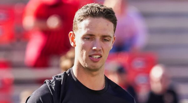 Carson Beck in black shirt