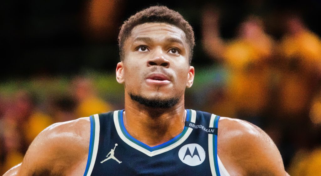 Giannis Antetokounmpo looking on.