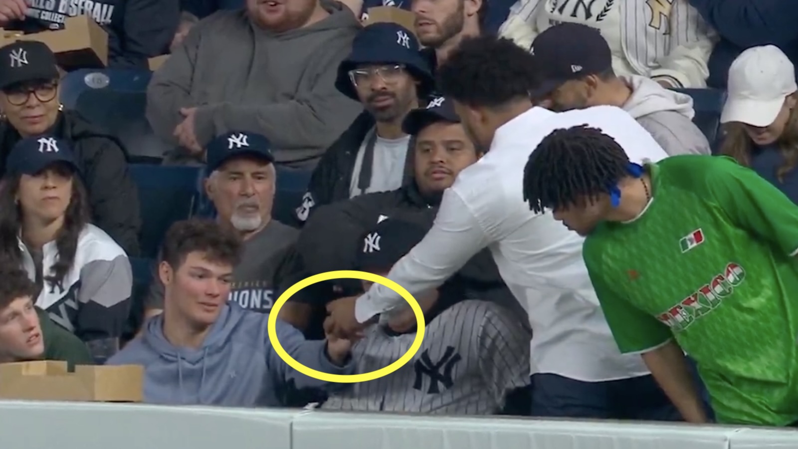 A Yankees fan hands over an Aaron Judge home run ball
