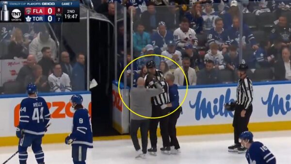 Referee Chris Rooney exits after taking stick near his eye