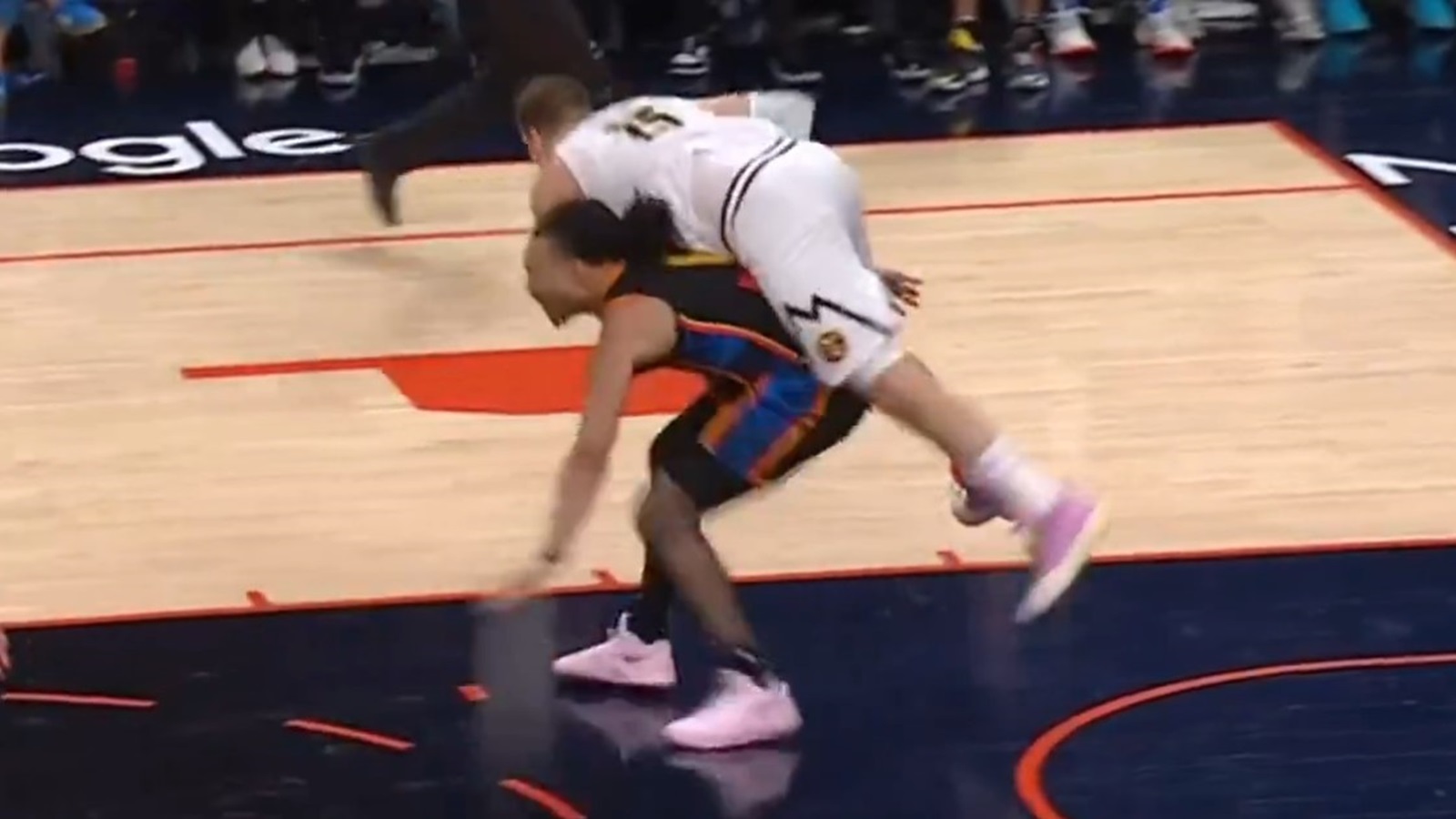 Nikola Jokic jumping on the back of Jaylin Williams