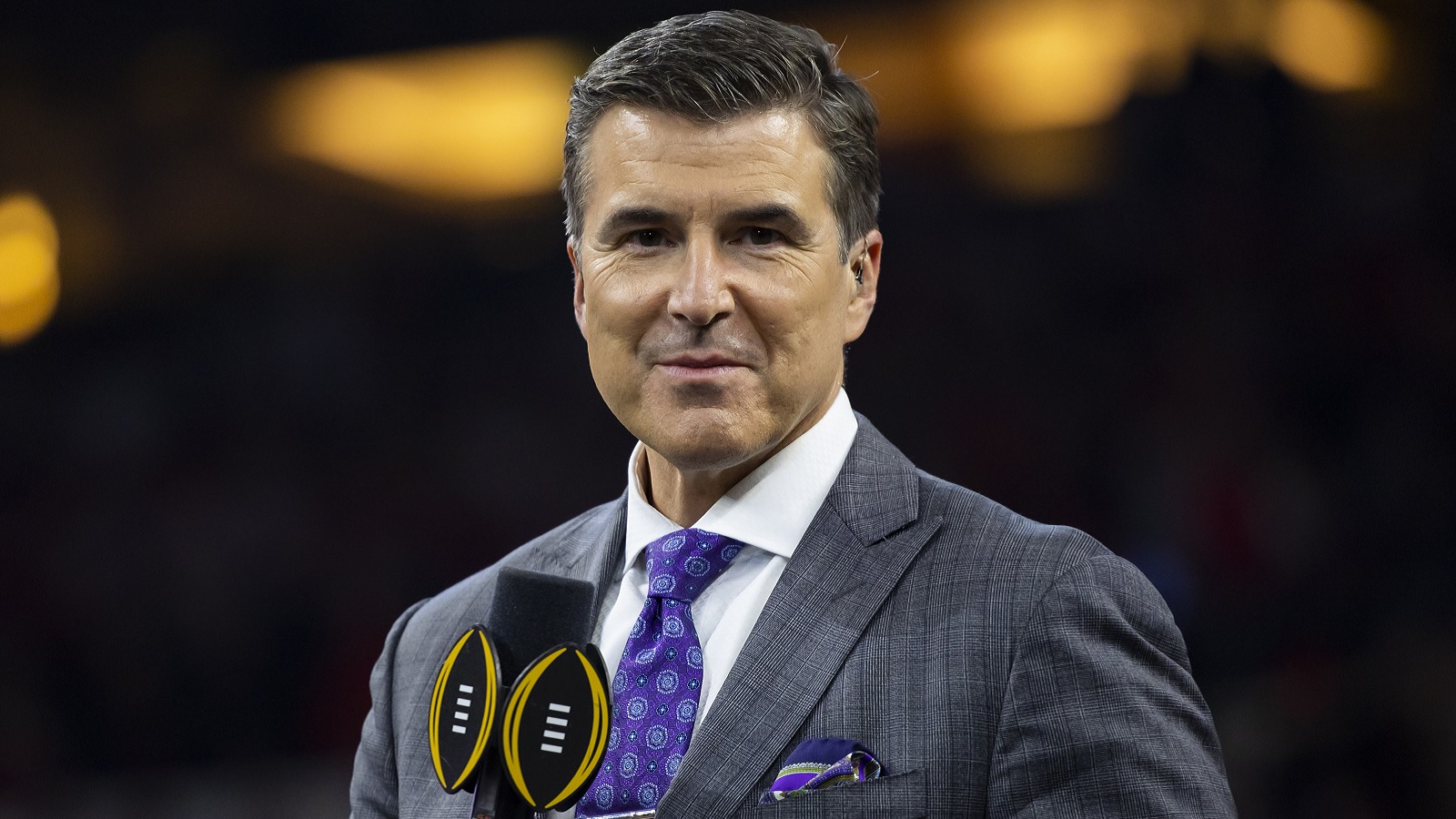 Rece Davis holding a microphone
